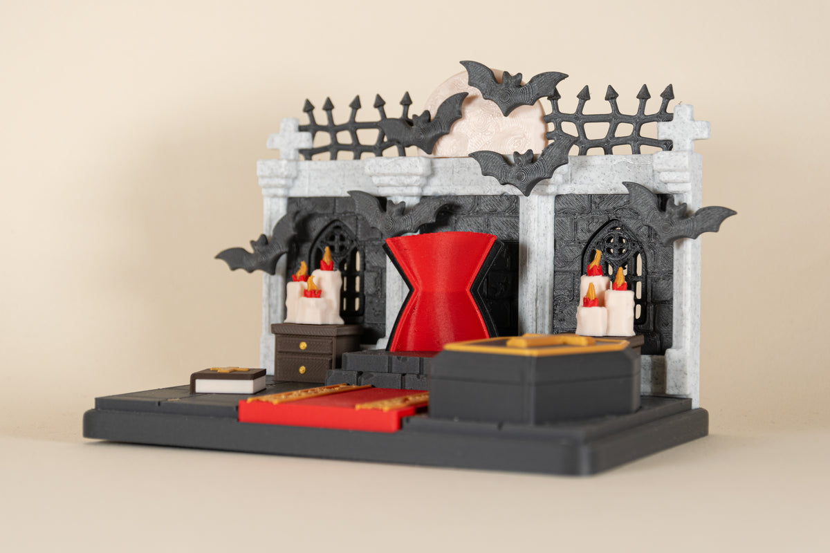 Le Repaire de Dracula MinoZoo en vue trois-quarts, avec trône rouge, cercueil noir et tapis rouge.