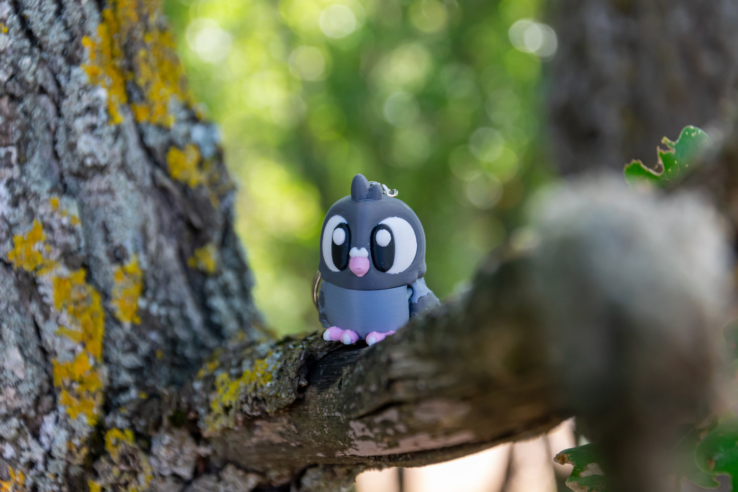Porte-clés Pigeon articulé MinoZoo gris bleuté et rose Sakura, posé de face sur une branche.