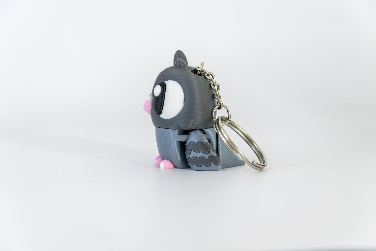 Porte-clés Pigeon articulé MinoZoo gris foncé et gris bleuté, vu de profil avec aile texturée.